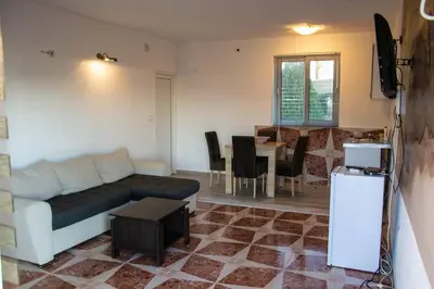 a living room with a couch and a table at Old Olive Tree Apartment in Bar