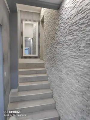 a stairway leading to a building with a stone wall at Apart102 in Budva