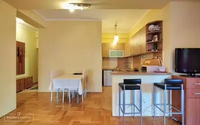 a kitchen with a table and chairs in a room at Квартира - Солнце in Budva