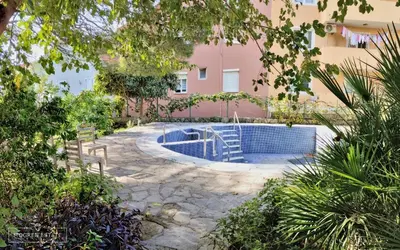 a swimming pool in the middle of a building at Квартира - Солнце in Budva