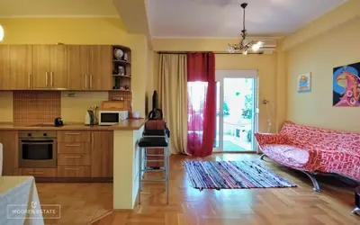 a kitchen with a red curtain and a table in a room at Квартира - Солнце in Budva
