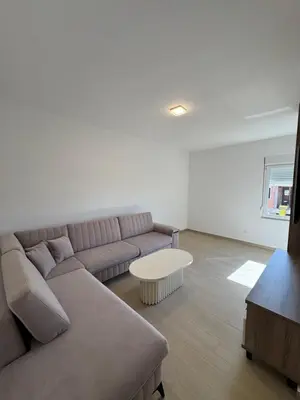 a living room with a couch and a table at Aron Apartment in Tuzi