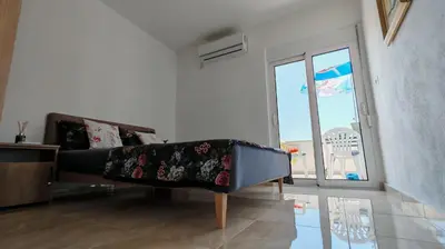 a living room with a couch and a sliding glass door at Una in Bregvija