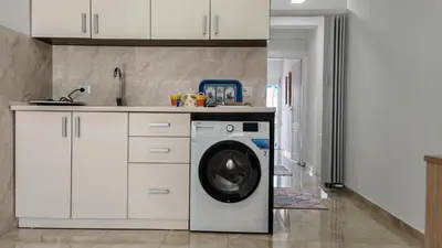 a kitchen with a washing machine in a kitchen at Una in Bregvija