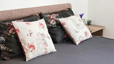 a group of pillows sitting on a bed at Una in Bregvija