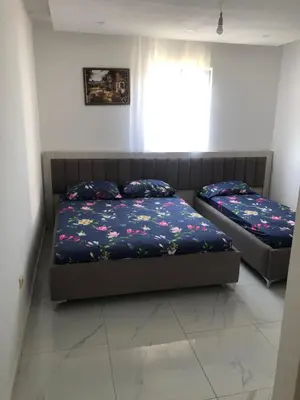 a bedroom with two beds and a window at Apartments Yrhan in Ulcinj