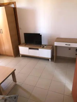 a living room with a tv and a table at Apartments Yrhan in Ulcinj