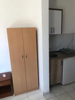 a kitchen with a wooden cabinet in a room at Apartments Yrhan in Ulcinj