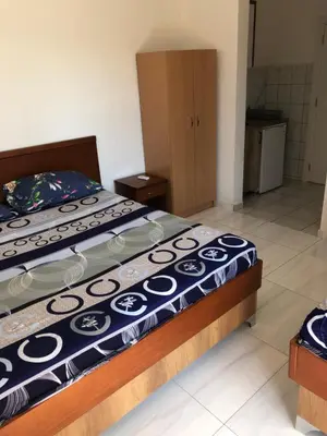 a bedroom with a bed with a blue and white comforter at Apartments Yrhan in Ulcinj