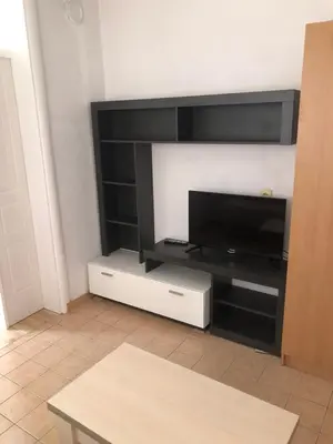 a living room with a flat screen tv on a wall at Apartments Yrhan in Ulcinj