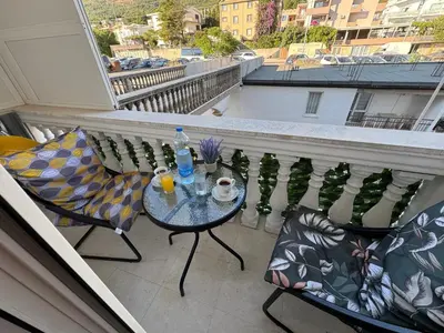 a balcony with a table and chairs on a balcony at Apartman Lord in Sutomore