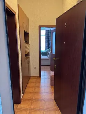 a hallway with a door leading to a living room at Apartman Lord in Sutomore
