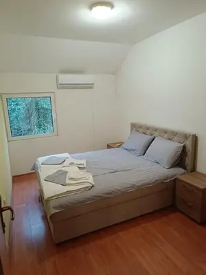 a bedroom with a bed in a room with a window at Una Apartments in Budva