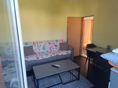 a living room with a couch and a table at Una Apartments in Budva