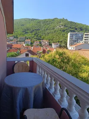 a balcony with a table and chairs with a view at Una Apartments in Budva