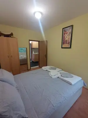 a bedroom with a bed with two towels on it at Una Apartments in Budva