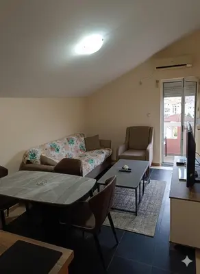 a living room with a couch and a table at Una Apartments in Budva