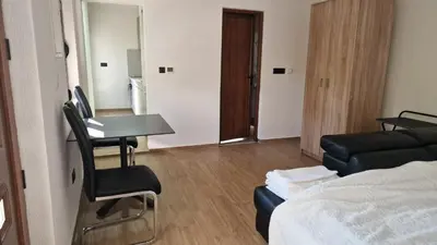 a room with a bed and a chair and a table at Sunset Villa in Bar