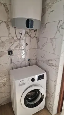 a white washer and dryer in a bathroom at Sunset Villa in Bar