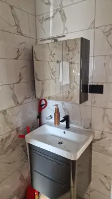 a bathroom with a sink and a mirror at Sunset Villa in Bar