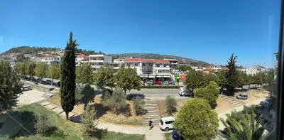 a view of a parking lot with trees and buildings at Apartman Sonib in Ulcinj