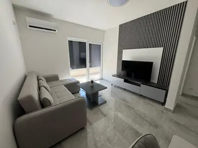 a living room with a couch and a flat screen tv at Mona in Ulcinj