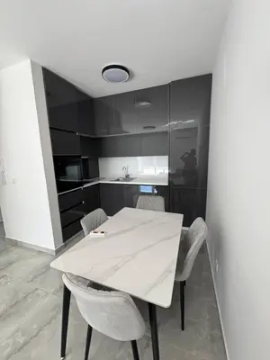 a kitchen with a white table and chairs at Mona in Ulcinj