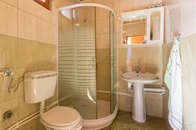 a bathroom with a toilet and a sink at Apartment Sjekloca in Virpazar