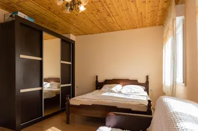 a bedroom with a bed and a wooden ceiling at Apartment Sjekloca in Virpazar