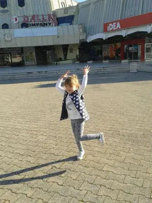 a little girl running in a street with her hands in the air at Apartment Sjekloca in Virpazar