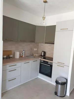 a kitchen with white cabinets and a stove top oven at Apartment Serenity Nest in Kotor