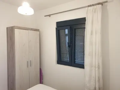a bedroom with a window and a cabinet at Apartment Serenity Nest in Kotor