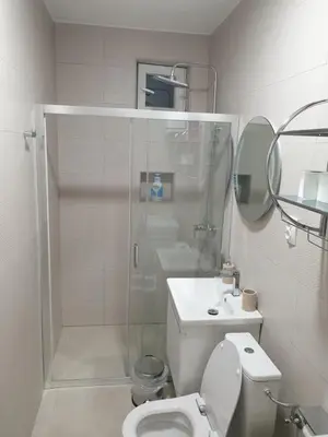 a bathroom with a shower and a toilet and a sink at Apartment Serenity Nest in Kotor