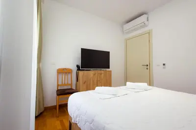 a bedroom with a bed and a flat screen tv at Hotel PIO in Ulcinj