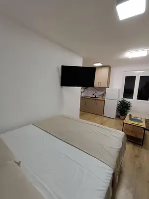 a bedroom with a bed and a flat screen tv at ApartmaniMD apartman 2 mirno utociste in Sutomore