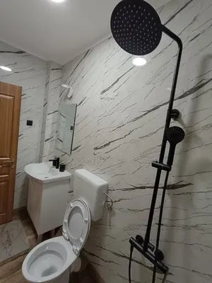a bathroom with a toilet and a light in it at ApartmaniMD apartman 2 mirno utociste in Sutomore