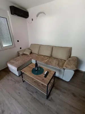 a living room with a couch and a coffee table at ApartmaniMD apartman 2 mirno utociste in Sutomore