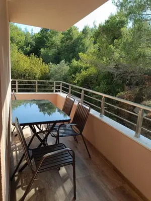 a balcony with two chairs and a table on it at ApartmaniMD apartman 5 uzivanje na pravom mjestu in Sutomore