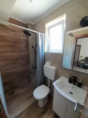 a bathroom with a toilet and a sink at ApartmentsMD apartman 6 najlepse sto zivot pruza in Sutomore