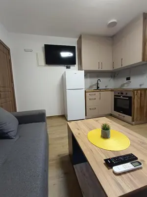 a kitchen with a table with a yellow plate on it at ApartmentsMD apartman 6 najlepse sto zivot pruza in Sutomore