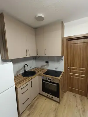 a small kitchen with white cabinets and a sink at ApartmentsMD apartman 6 najlepse sto zivot pruza in Sutomore