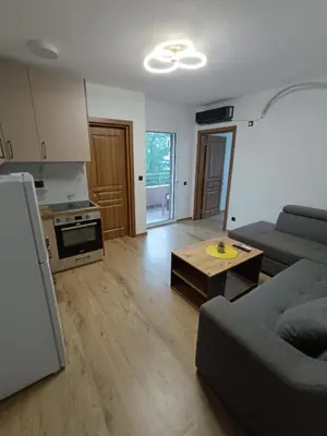 a living room with a couch and a table at ApartmentsMD apartman 6 najlepse sto zivot pruza in Sutomore