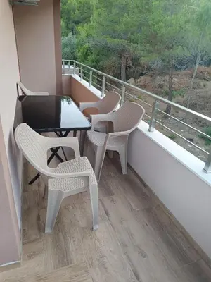 a balcony with two chairs and a table and a window at ApartmentsMD apartman 6 najlepse sto zivot pruza in Sutomore