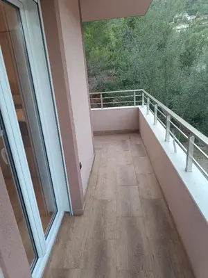 a balcony of a house with a large window at ApartmentsMD apartman 6 najlepse sto zivot pruza in Sutomore