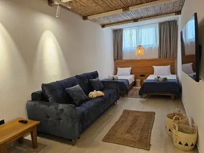 a living room with a couch and two beds at High-End Villa with Private Beach Access in Brca