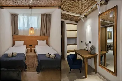 a bedroom with two beds and a desk with a mirror at High-End Villa with Private Beach Access in Brca