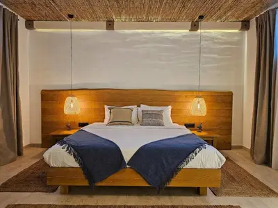 a bedroom with a large bed with two lamps at High-End Villa with Private Beach Access in Brca