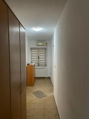 an empty hallway with a door and a room with a table at Apartman Anastasija in Kotor