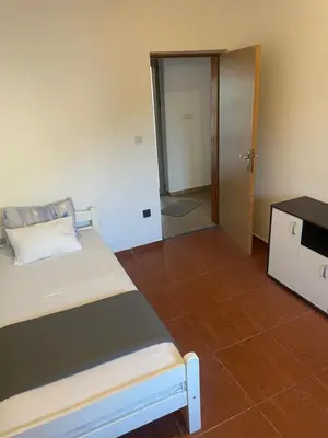 a bedroom with a bed and a door to a hallway at Apartman Anastasija in Kotor