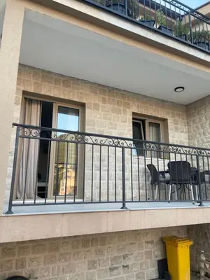 a balcony with black railings on a building at Apartman Anastasija in Kotor